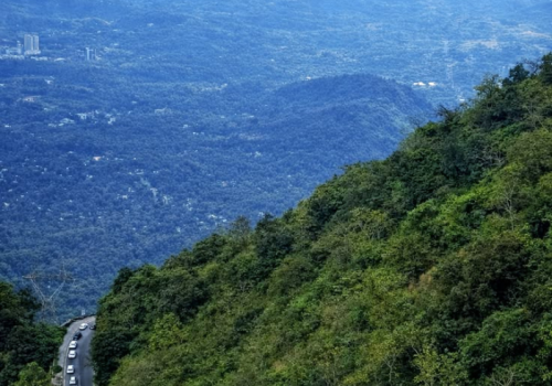 Panoramic view of the winding roads and misty mountain valleys at Lakkidi.